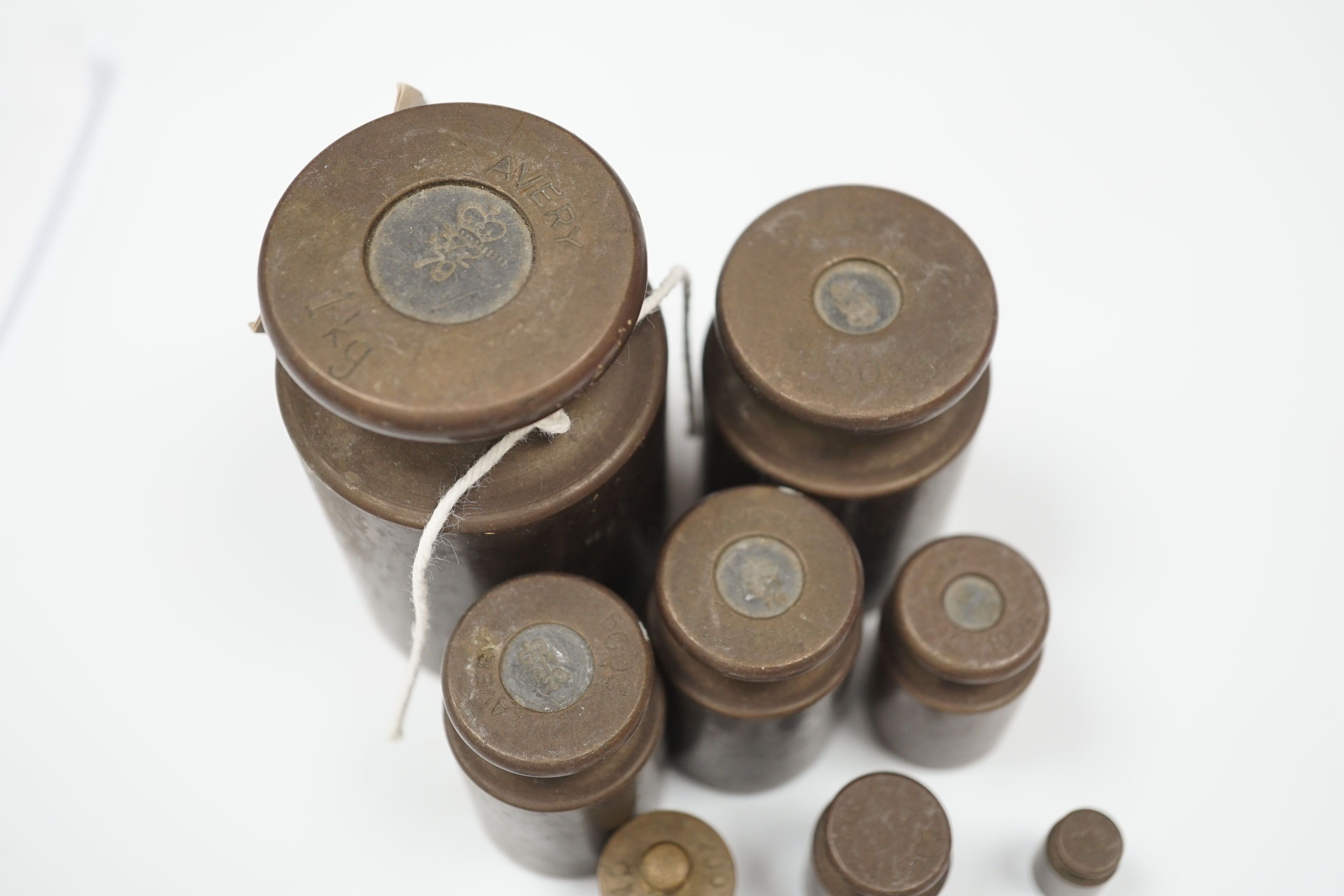 A set of fourteen graduated Avery weights, largest 8cm high